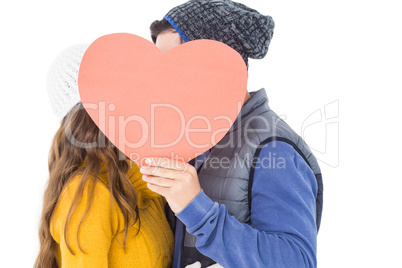 Happy couple holding paper heart