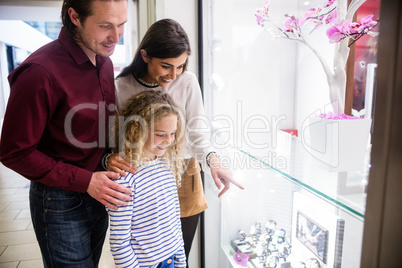 Happy family window shopping in mall