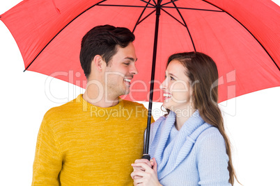 Happy couple holding an umbrella