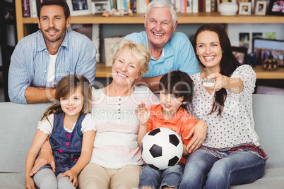 Smiling family watching football match