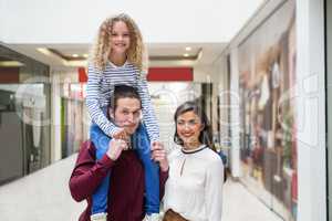 Portrait of happy family in shopping mall