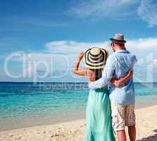 Vacation Couple walking on tropical beach Maldives.