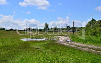 Rural summer landscape with the image of the old village