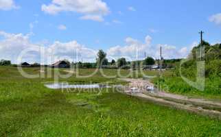 Rural summer landscape with the image of the old village