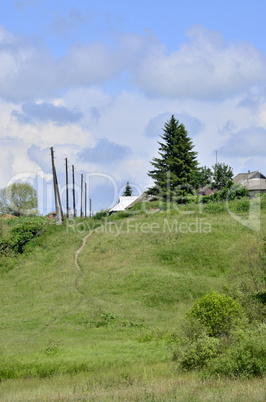 Rural summer landscape with the image of the old village