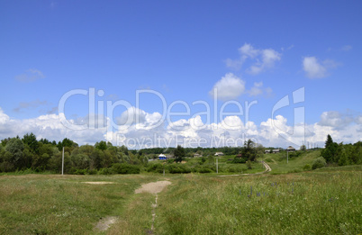 Rural summer landscape with the image of the old village