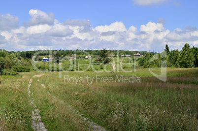 Rural summer landscape with the image of the old village