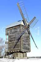 Old wooden windmill close up in winter