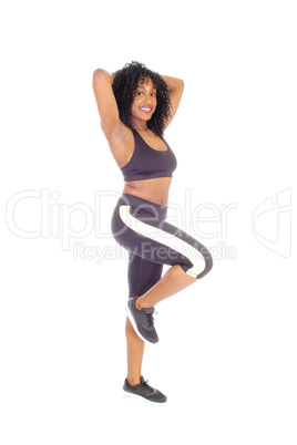 African American woman standing in exercise outfit.