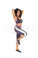 African American woman standing in exercise outfit.