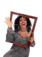 African American woman holding a picture frame.