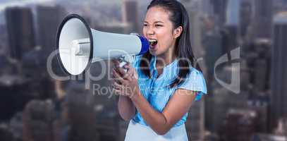 Composite image of businesswoman shouting into a megaphone