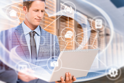 Composite image of businessman holding his laptop