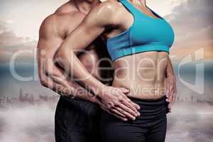 Composite image of midsection of healthy couple with hands on hi