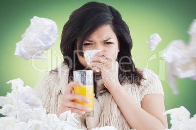 Composite image of woman holding a glass of orange juice while s