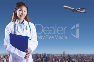 Composite image of asian doctor holding blue binder