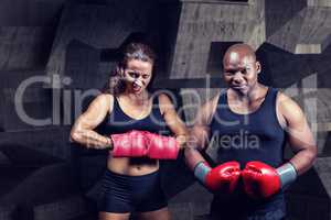 Composite image of portrait of male and female boxers with glove