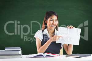 Composite image of smiling businesswoman pointing a sheet of pap