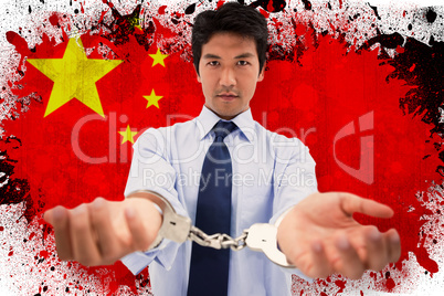 Composite image of businessman with handcuffs