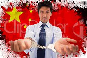 Composite image of businessman with handcuffs