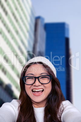 Composite image of asian woman smiling at the camera