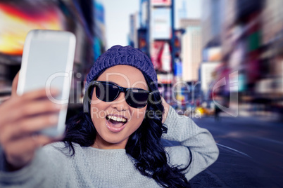 Composite image of asian woman taking selfie