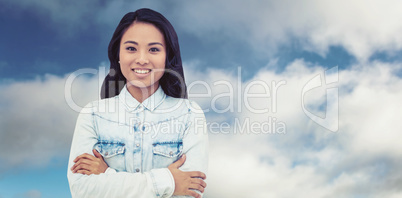 Composite image of asian woman with arms crossed smiling
