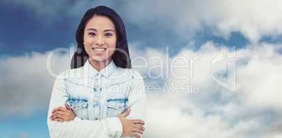 Composite image of asian woman with arms crossed smiling