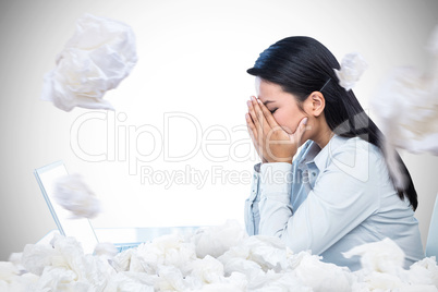 Composite image of worried businesswoman covering face