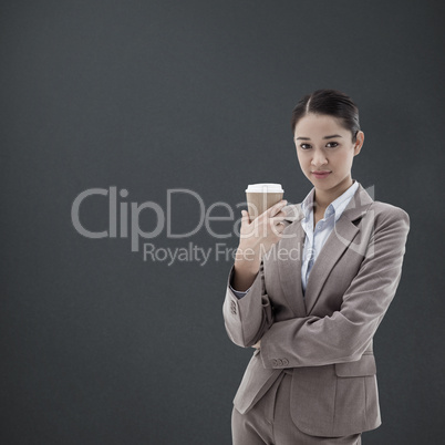 Composite image of portrait of a businesswoman holding a takeawa
