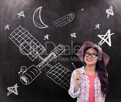 Composite image of smiling asian woman with hat holding pencil
