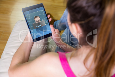 Composite image of woman using tablet at home