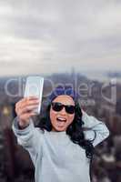 Composite image of asian woman taking selfie