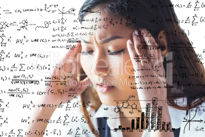 Composite image of nervous businesswoman holding her head