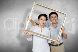 Composite image of older asian couple with frame