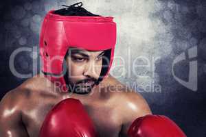 Composite image of muscular man boxing in gloves