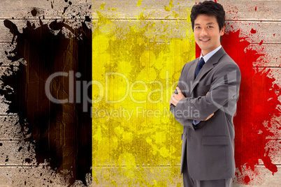 Composite image of portrait of a smiling businessman with the ar