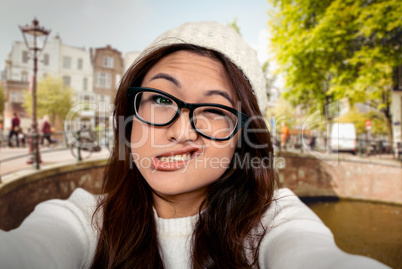 Composite image of asian woman making faces