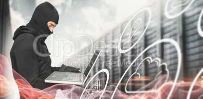 Composite image of side view of hacker using laptop