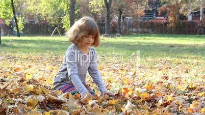 little girl fun with autumn leaves