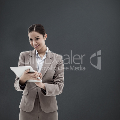 Composite image of portrait of a smiling businesswoman using a t