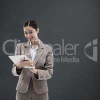 Composite image of portrait of a smiling businesswoman using a t