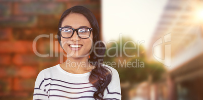 Composite image of smiling asian woman with arms crossed looking