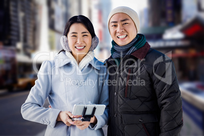 Composite image of cheerful couple against buildings