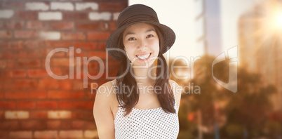 Composite image of cheerful woman with a polka dot dress and hat