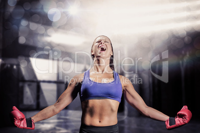 Composite image of winning fighter with arms outstretched