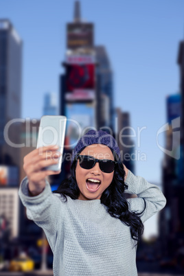 Composite image of asian woman taking selfie