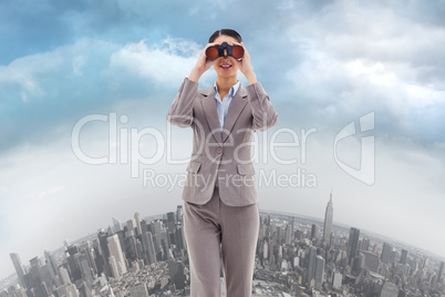 Composite image of portrait of a businesswoman looking through b