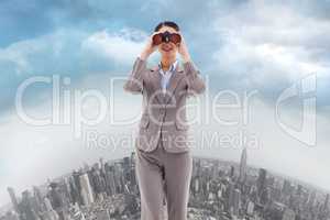 Composite image of portrait of a businesswoman looking through b