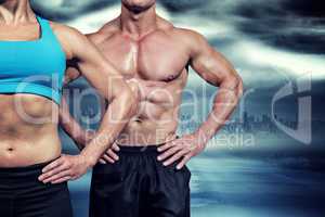Composite image of midsection of muscular woman and man standing